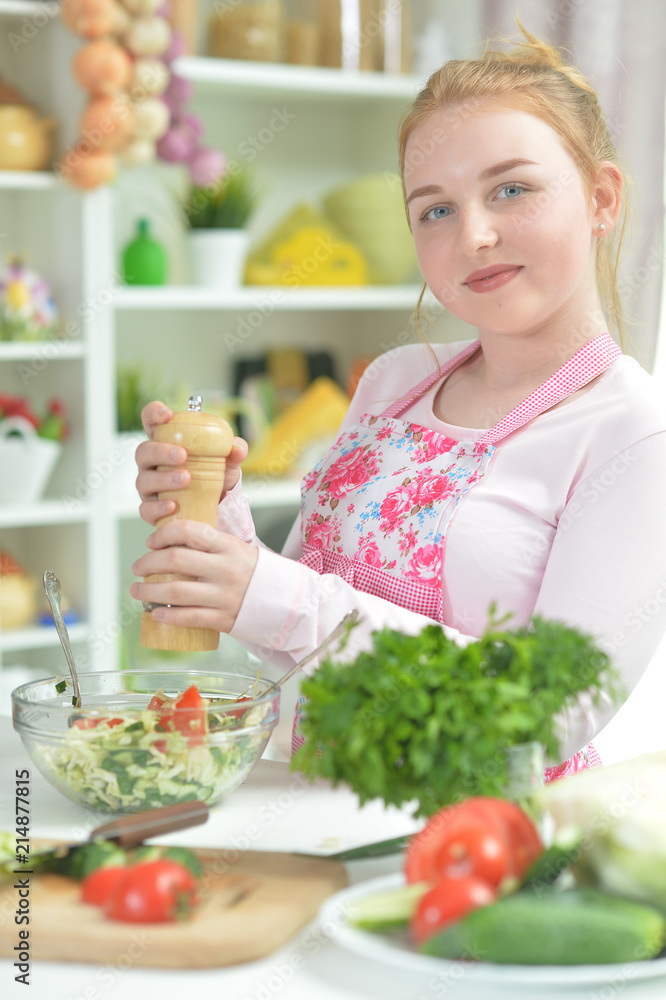 Cute teen girl preparing fresh salad Cute teen girl preparing fresh salad