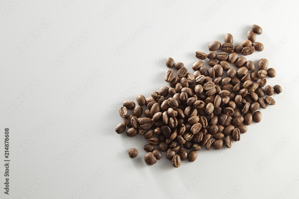 roasted coffee beans poured from clear glass