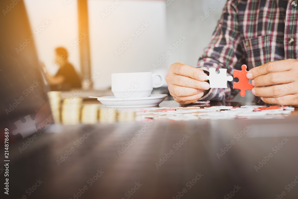 Hand holding piece of blank jigsaw puzzle on wooden background. Hand holding piece of blank jigsaw puzzle on wooden background.