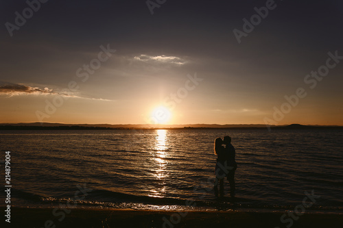 Silhouette couples in the sea at sunset