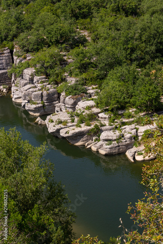 View of the river Ardeche, framed by rock faces and a lot of vegetation at "Cirque des Gens" in the department Ardeche in the south of France