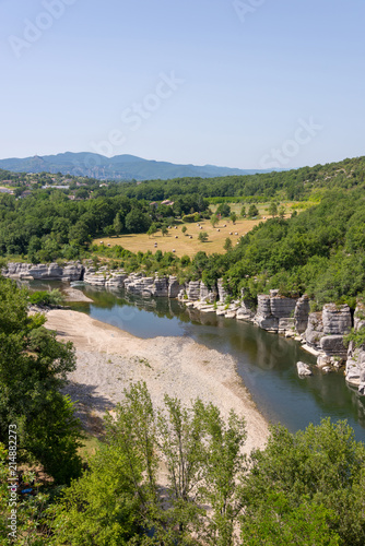 Landscape with the river Ardeche, framed by rock faces and much vegetation at "Cirque des Gens" in the department Ardeche in the south of France