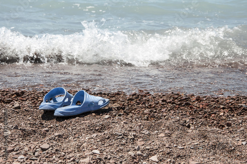 Beach slippers in the sand on beach