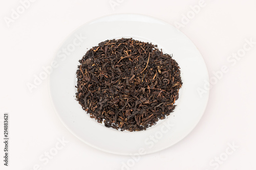 pile of dry tea leaves on white plate