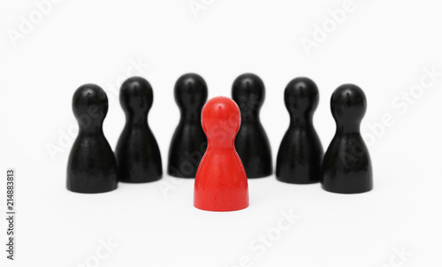 Einzelgänger Rote Spielfigur im Vordergrund mit schwarzen Hintermännern