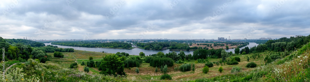 Panorama with the river and city buildings on the horizon. Kolomenskoye, Moscow, Russia