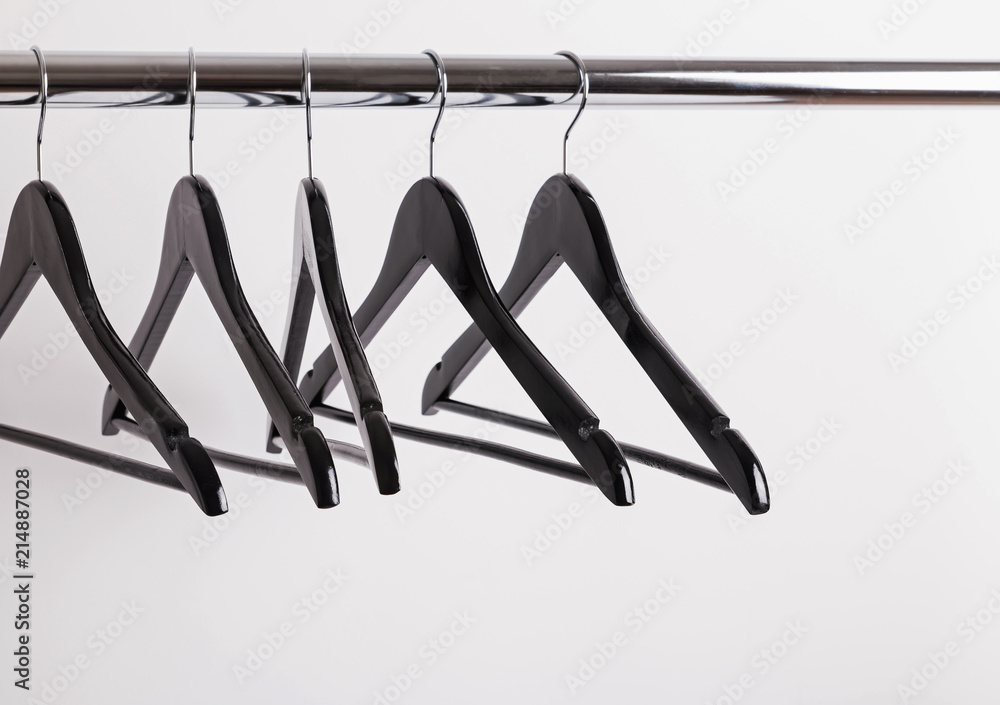 Some empty hangers on the rack.