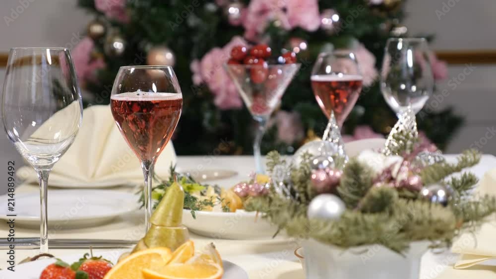 Restaurant concept. New Year and Merry Christmas feast table. champagne bubbles in glass. Sliced fruit dish, cheese plate and champagne in glasses are beautifully served on celebration table Restaurant concept. New Year and Merry Christmas feast table. champagne bubbles in glass. Sliced fruit dish, cheese plate and champagne in glasses are beautifully served on celebration table