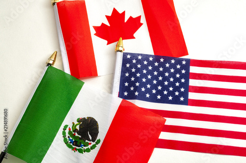 North American Free Trade Agreement or Nafta and 2026 football world cup organizing countries concept with close up on the flags of Mexico, USA and Canada photo