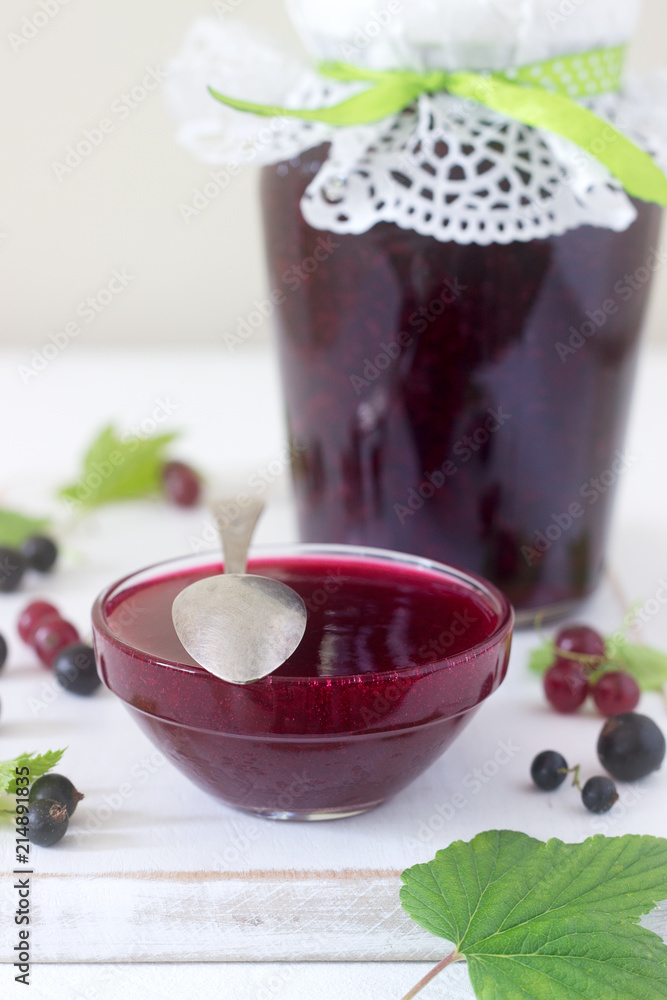 Jam or marmalade of black and red currant and currant berries on a light background. Jam or marmalade of black and red currant and currant berries on a light background.