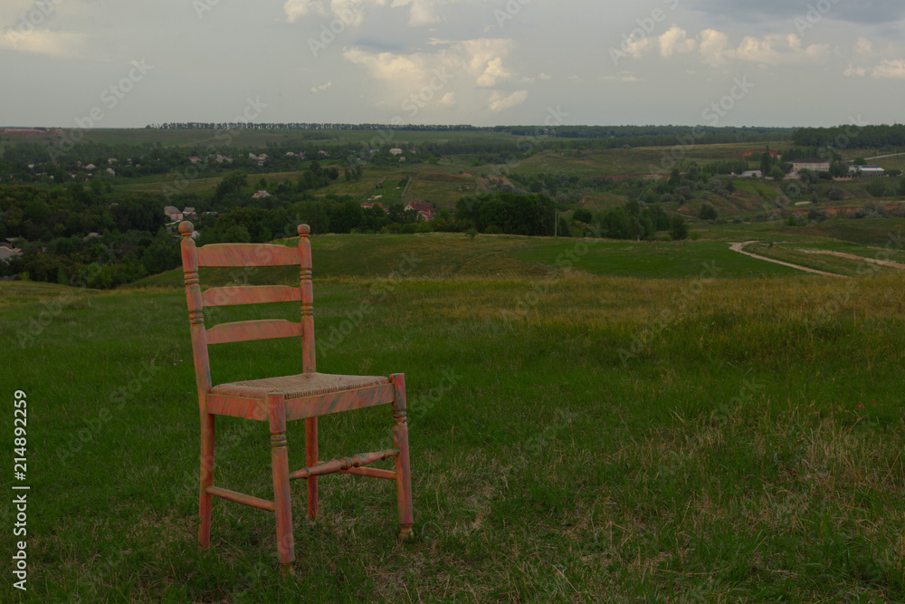 chair on green grass cloudy sky in summer background village chair on green grass cloudy sky in summer background village