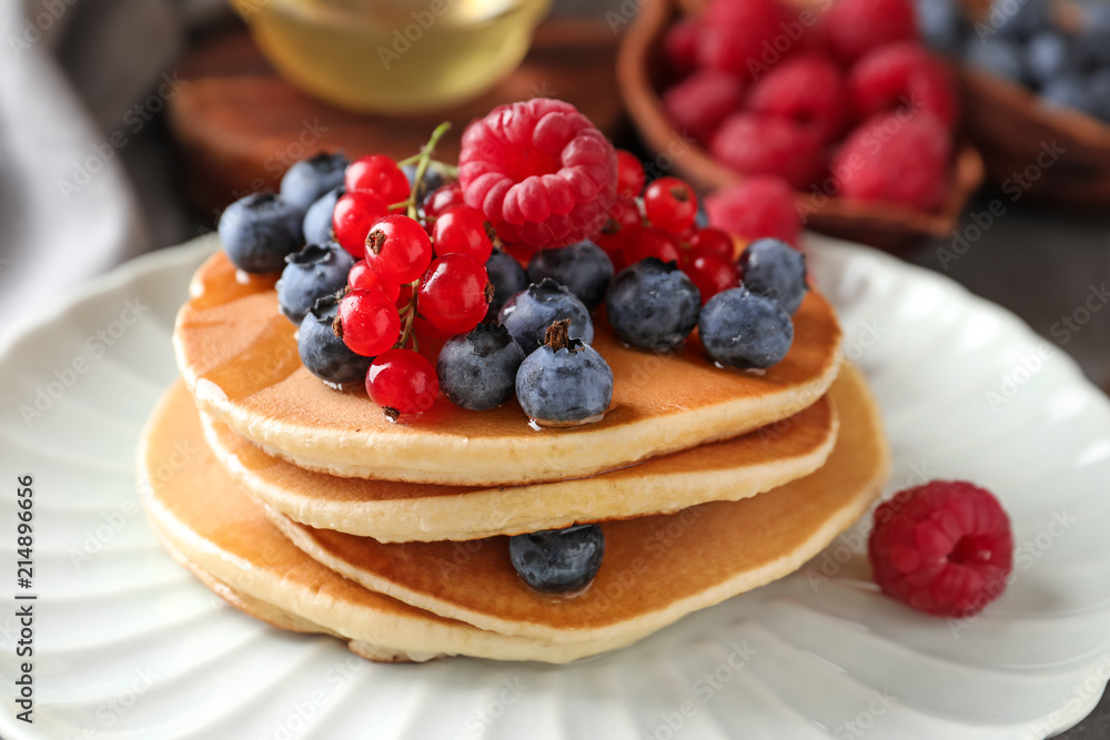 Tasty homemade pancakes with berries on plate, closeup Tasty homemade pancakes with berries on plate, closeup