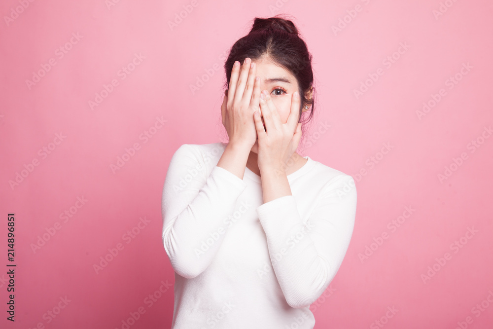 Beautiful young Asian woman peeking through fingers. Beautiful young Asian woman peeking through fingers.