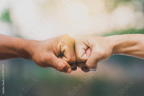 Man giving fist bump in nature background. power of teamwork concept. vintage tone photo