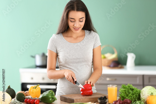Young pregnant woman making...