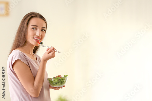 Young pregnant woman eating...