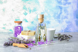 Bottle of essential oil with lavender on table
