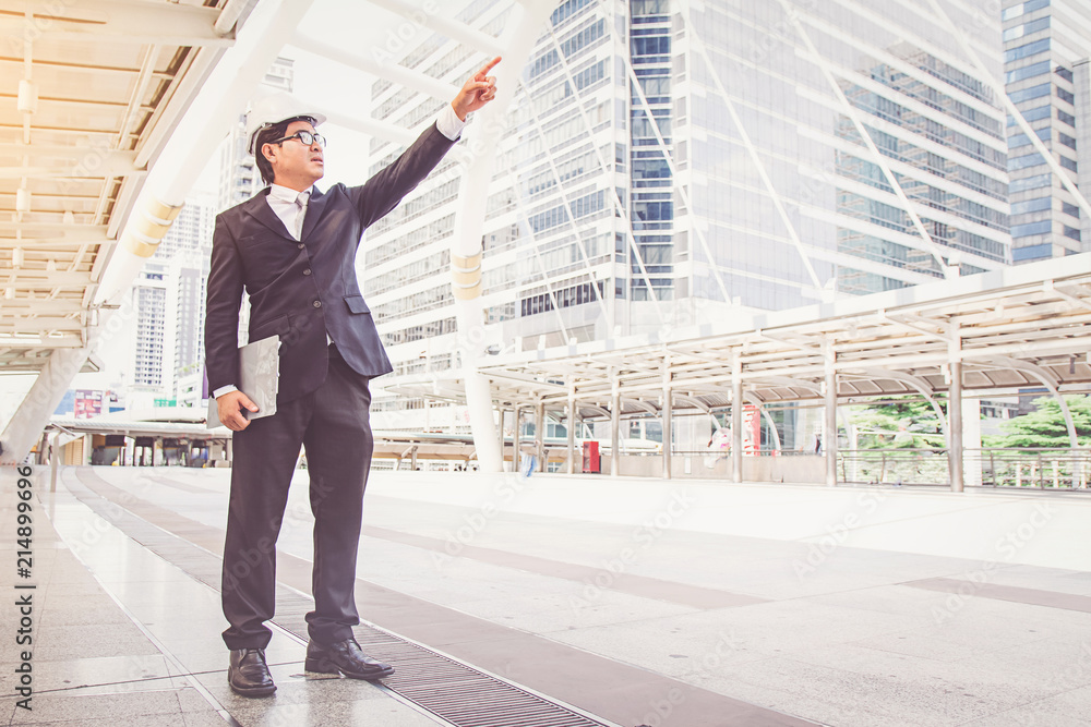 Businessman planning construction project Businessman planning construction project