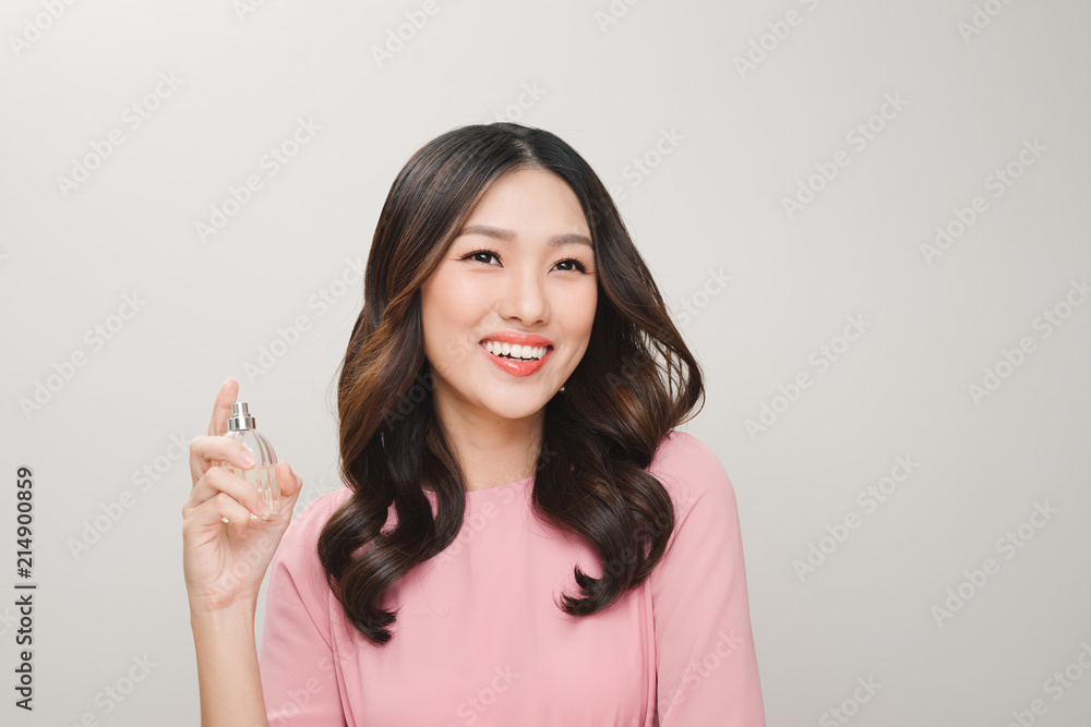 Young beautiful woman with bottle of perfume. Perfect Makeup. Fashion photo Young beautiful woman with bottle of perfume. Perfect Makeup. Fashion photo