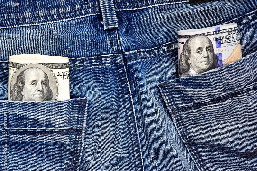 The president Franklin on a 100 dollar bill peeps out of his jeans pocket. New and old design. Concept on the topic of illegal work. The president Franklin on a 100 dollar bill peeps out of his jeans pocket. New and old design. Concept on the topic of illegal work.