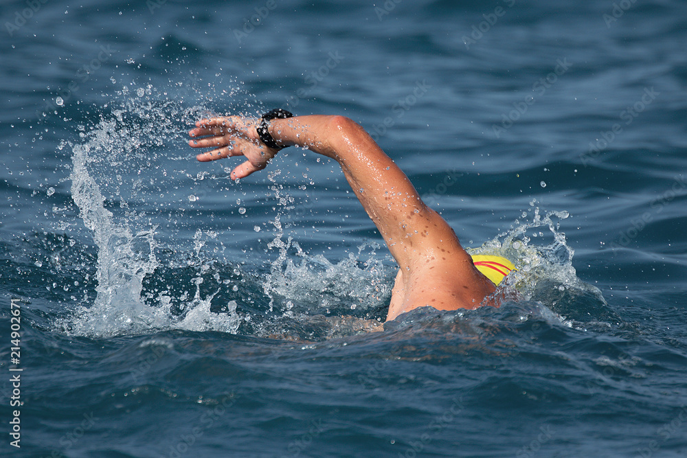Man swimmer swimming crawl in blue sea