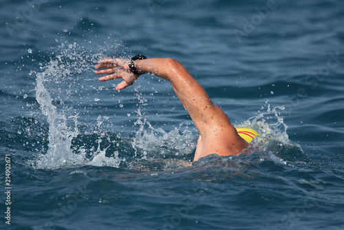 Man swimmer swimming crawl in blue sea
