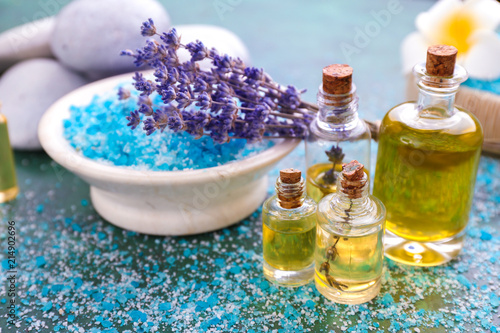 Composition with sea salt, essential oil and lavender on table