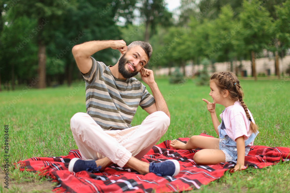 Funny portrait of little girl and her father outdoors