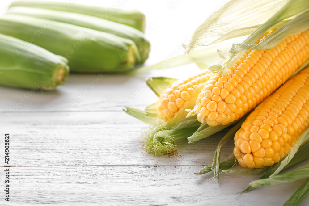 Tasty corncobs on wooden table