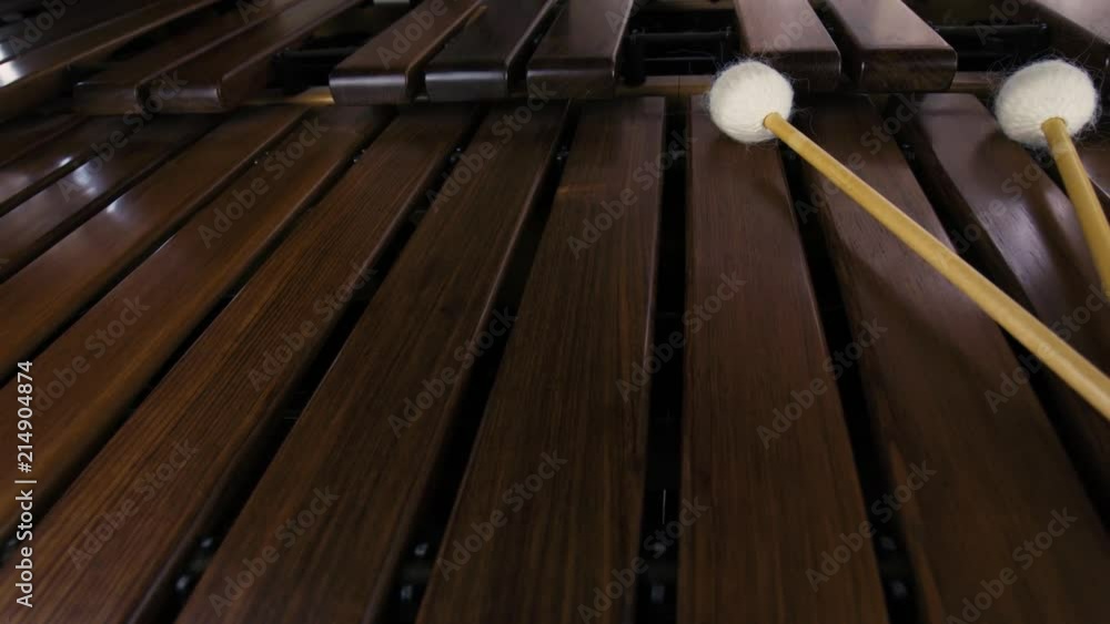 Slider shot of a marimba with four white mallets. Wide angle lens. Slider shot of a marimba with four white mallets. Wide angle lens.