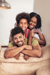 Happy family posing on the couch together at home in the living room
