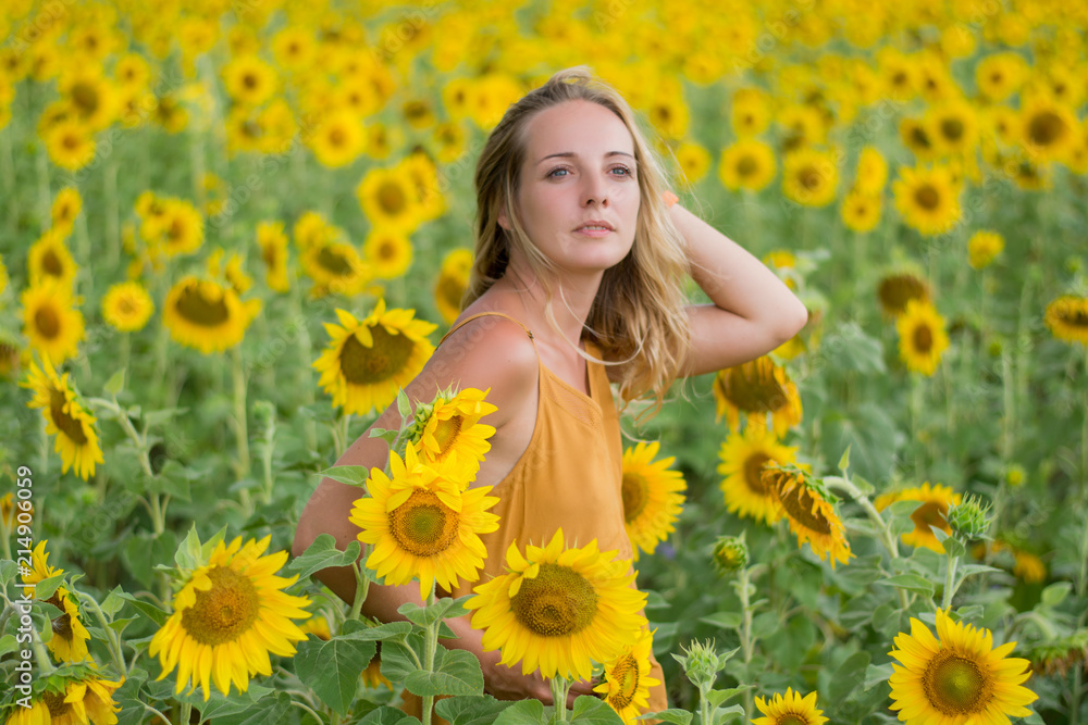 Happy woman with sunflowers. The girl in the fields of a sunflower Happy woman with sunflowers. The girl in the fields of a sunflower