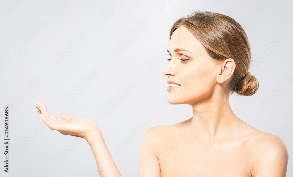 Woman Portrait. Beautiful Spa Girl showing empty copy space on the open hand palm for text. Proposing a product. Skin Care Concept. On white with clipping path Woman Portrait. Beautiful Spa Girl showing empty copy space on the open hand palm for text. Proposing a product. Skin Care Concept. On white with clipping path