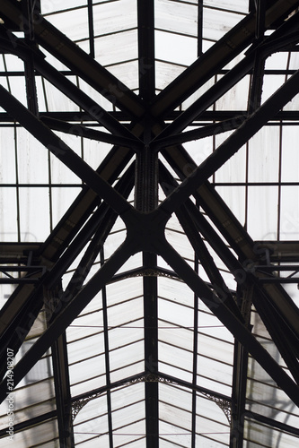 Detail of the ironwrought and glass topped roof of a British railway station