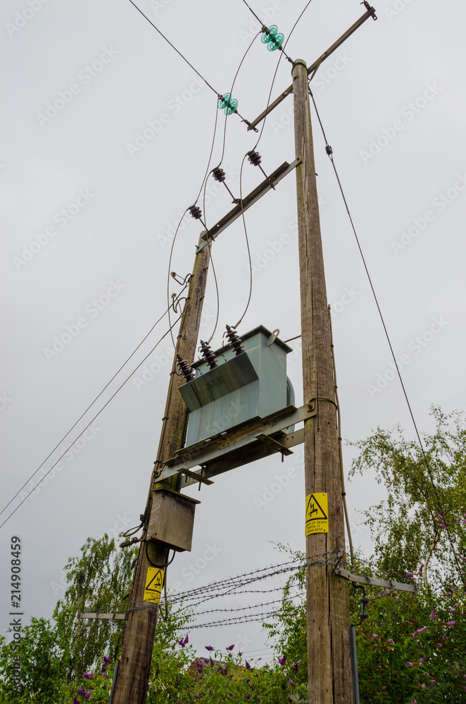 Electricity transformer high on wood mounting outdoors