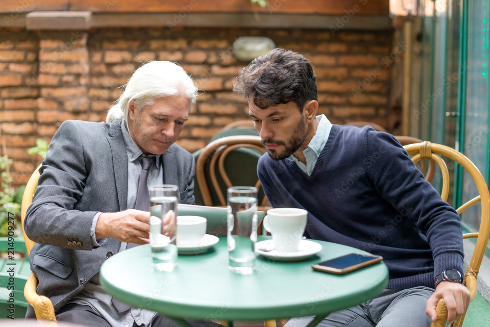 Two colleagues have a meeting in the cafe Two colleagues have a meeting in the cafe