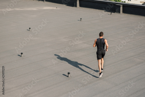 high angle view of sportsman running on roof