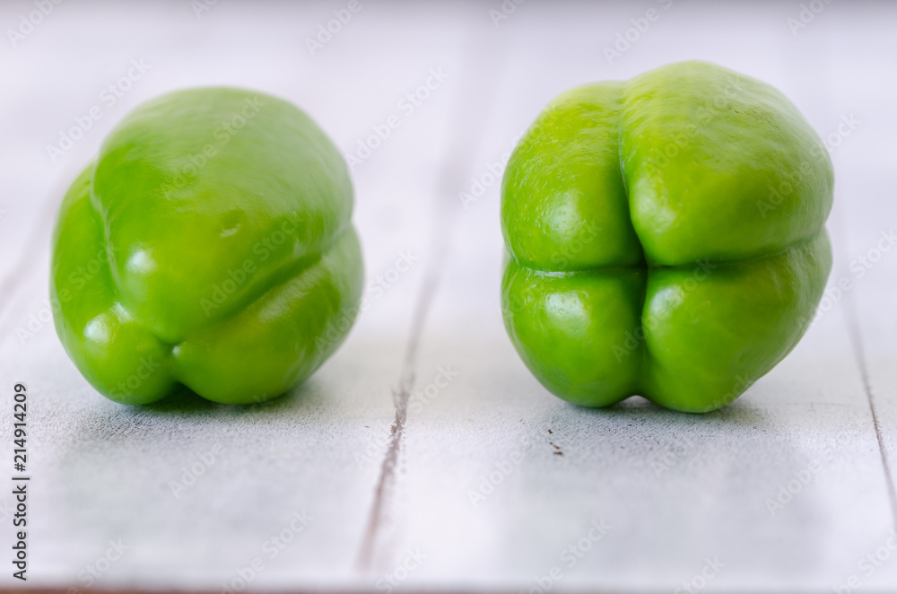 Raw and Fresh Green Organic Bell Peppers On Wooden Table. Raw and Fresh Green Organic Bell Peppers On Wooden Table.