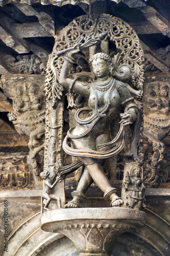 Shilabalika, celestial maiden, as a Kapikupite. Monkey, in the bottom left corner, pulling Saree. Chennakeshava temple, Belur, Karnataka. Notice the hairstyle.