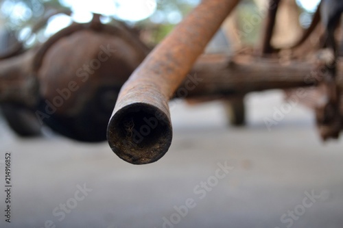 Closeup view of an exhaust taill pipe from vintage car chassis 