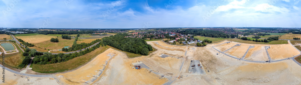 Panorama in high resolution, composed of photos with the drone, with a view of a new development with several streets and dead ends, old village in the background
