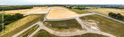 Panorama in high resolution, composed of photos with the drone, with a view of a new development with several streets and dead ends, undeveloped