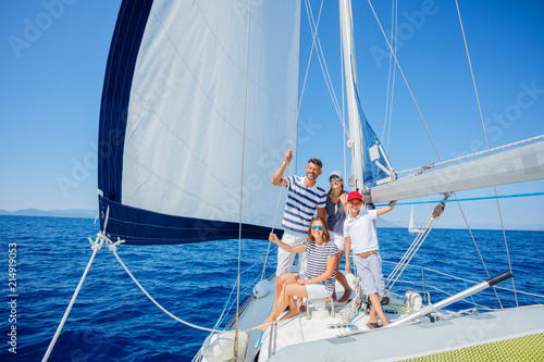 Family with adorable kids resting on yacht