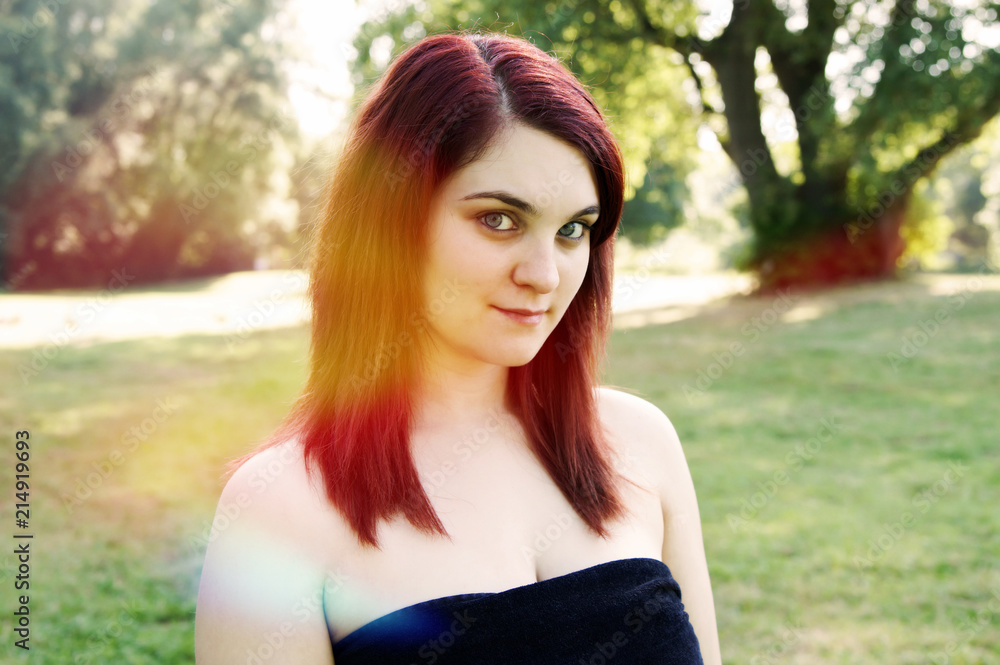 outdoor portrait of a young woman. with sun flare filter effect outdoor portrait of a young woman. with sun flare filter effect