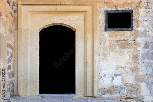 Door and window in a stone wall isolated on black background with copy space