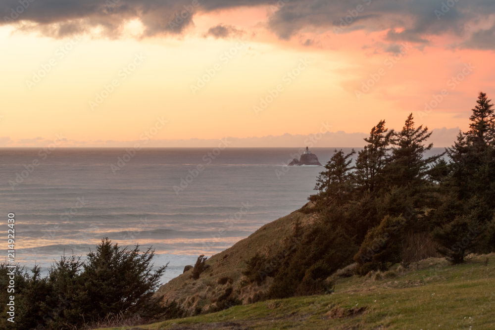Sunset over Pacific Ocean with  Tillamook Rock Light on the horizon, Oregon