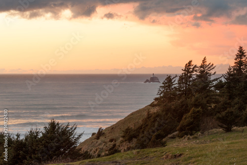 Sunset over Pacific Ocean with  Tillamook Rock Light on the horizon, Oregon photo