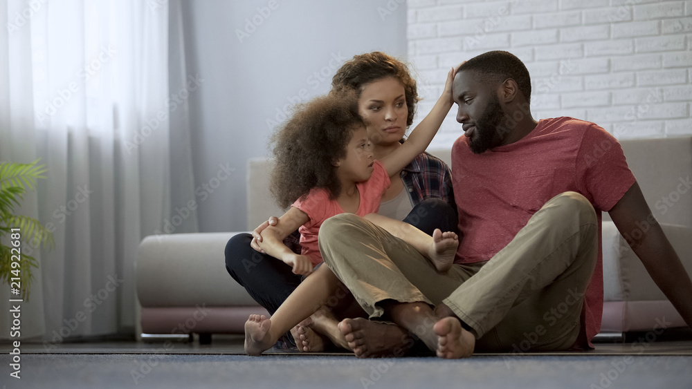 Obraz premium Caring daughter touching fathers forehead, checking temperature of sick dad