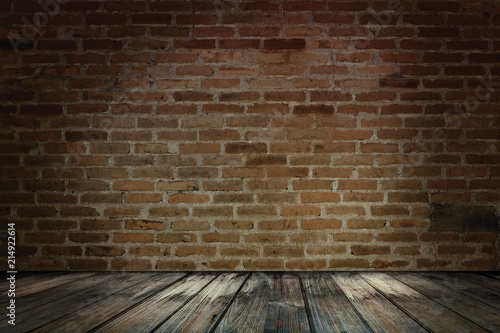 Dark wooden over grunge red brick wall. Red brick wall and wooden floor.