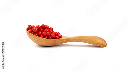 Wooden scoop spoon full of pink peppercorns